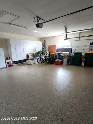 a view of a garage with cars and a garage