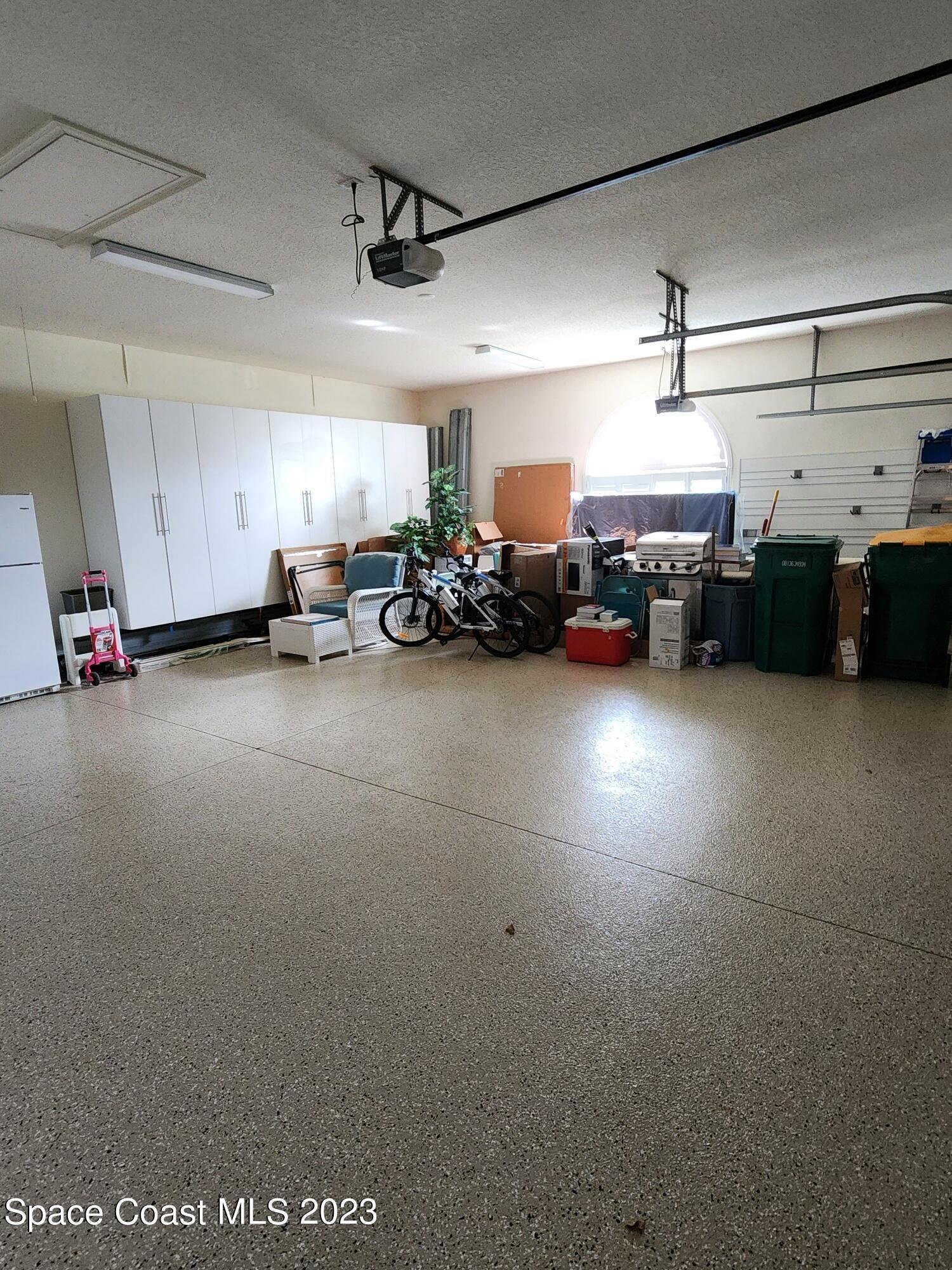 4124 Waterloo Place Melbourne, FL 32940 - Photo 15 of 32 a view of a garage with cars and a garage