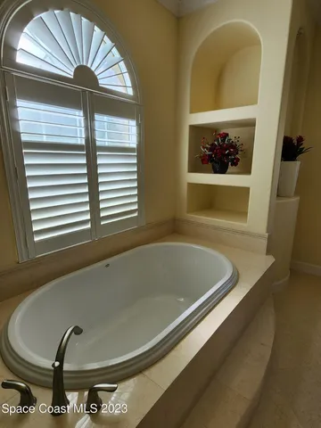 a bathroom with a tub and a window