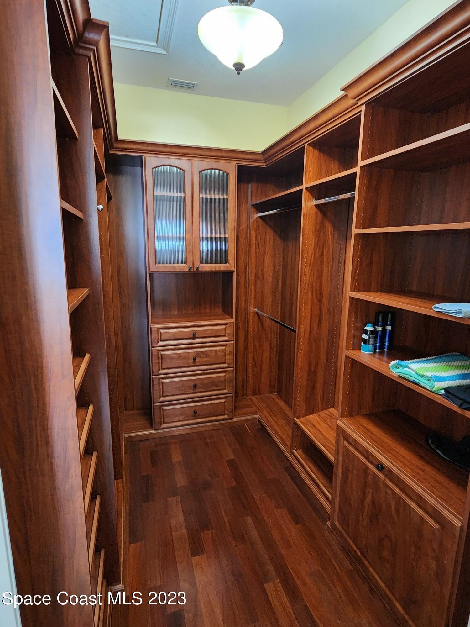 4124 Waterloo Place Melbourne, FL 32940 - Photo 21 of 32 a view of walk in closet with clothes and shoes