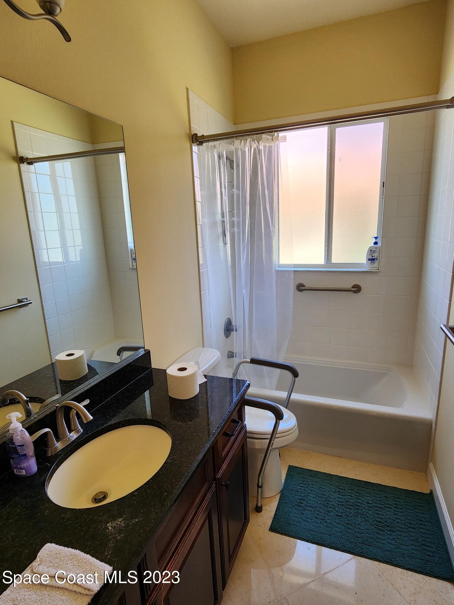 4124 Waterloo Place Melbourne, FL 32940 - Photo 24 of 32 a bathroom with a sink a toilet and a bathtub