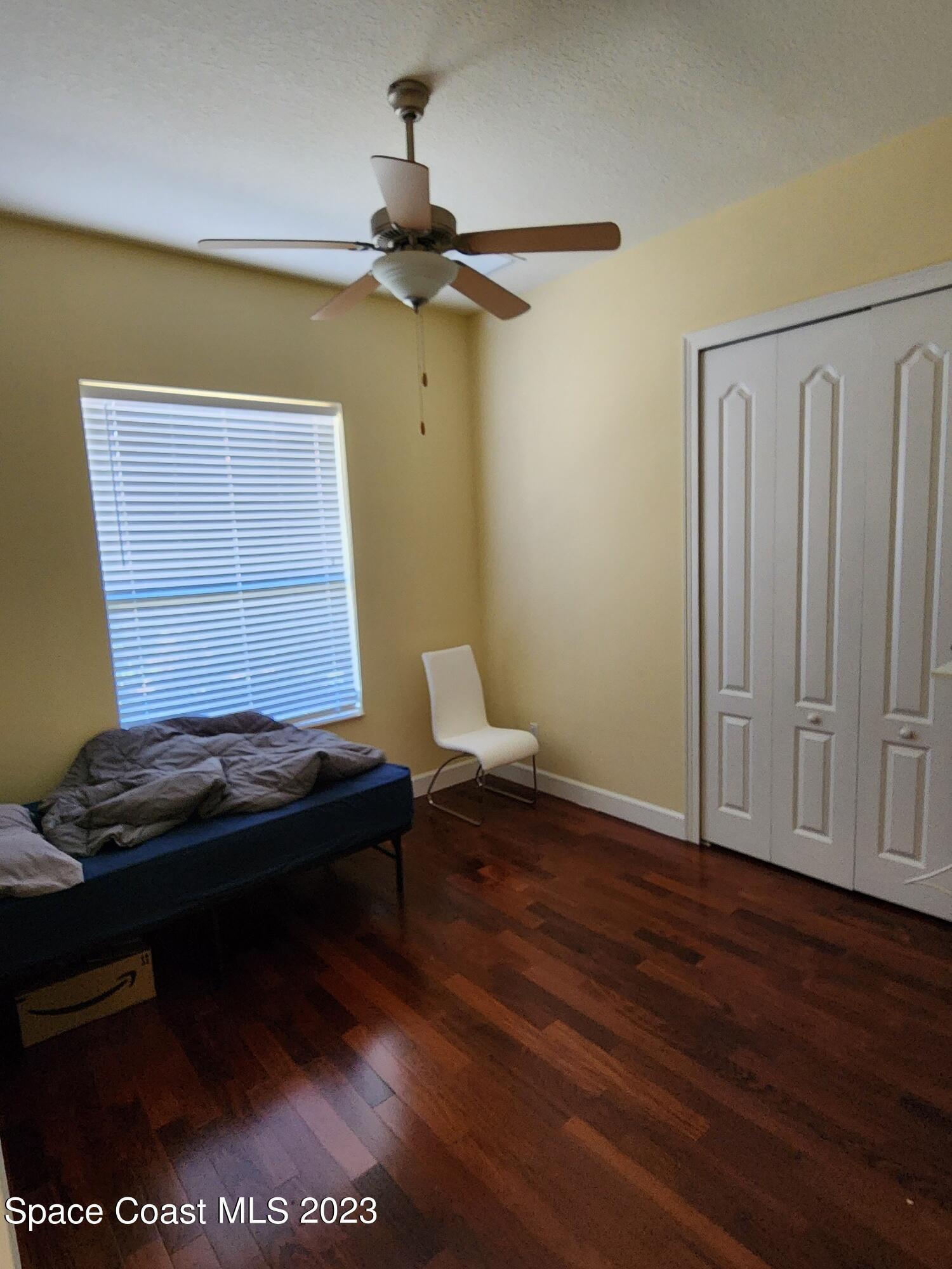 4124 Waterloo Place Melbourne, FL 32940 - Photo 26 of 32 a living room with a couch and a window