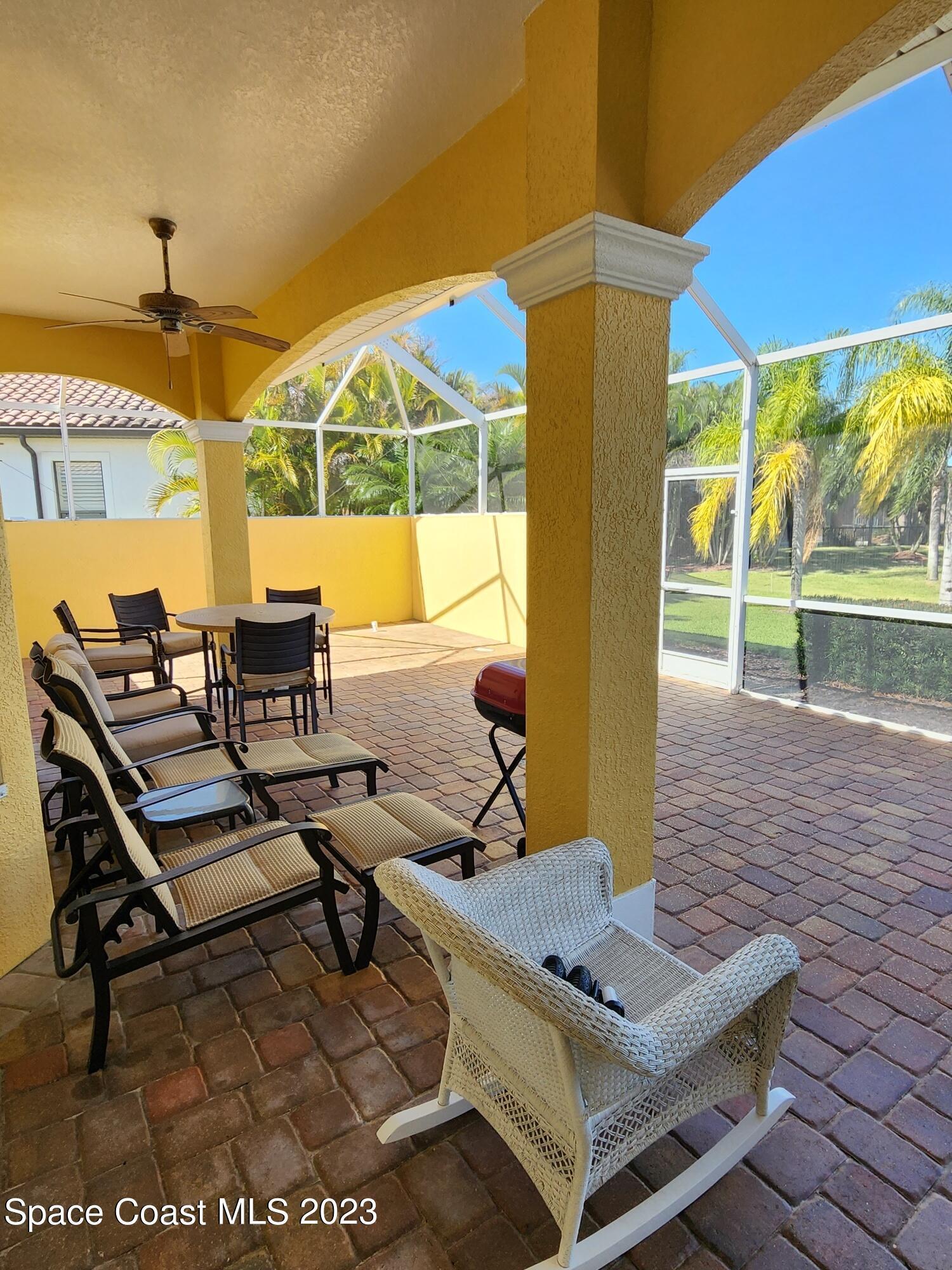 4124 Waterloo Place Melbourne, FL 32940 - Photo 28 of 32 a view of a patio with a table and chairs