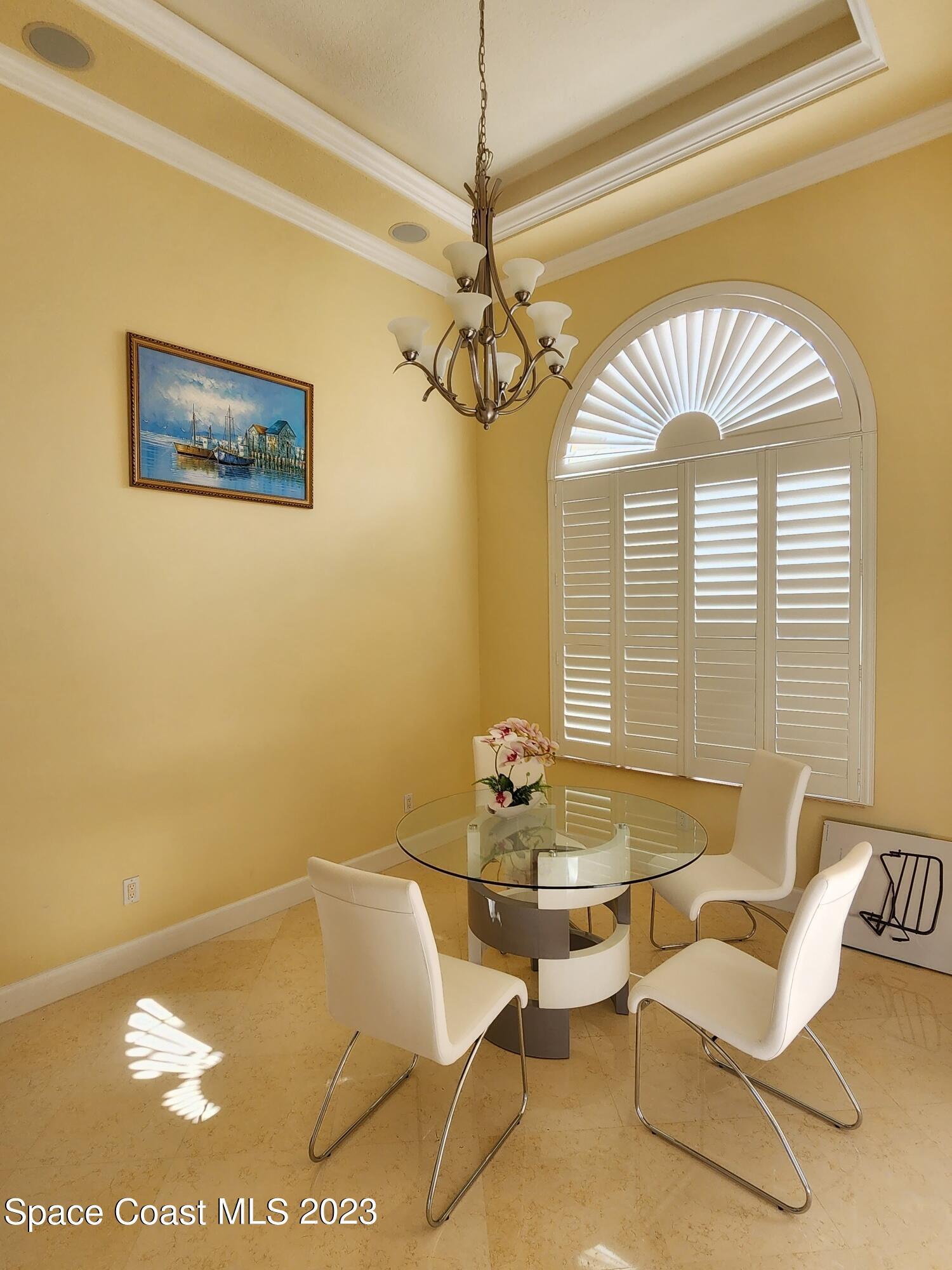 4124 Waterloo Place Melbourne, FL 32940 - Photo 6 of 32 a dining room with furniture and a chandelier