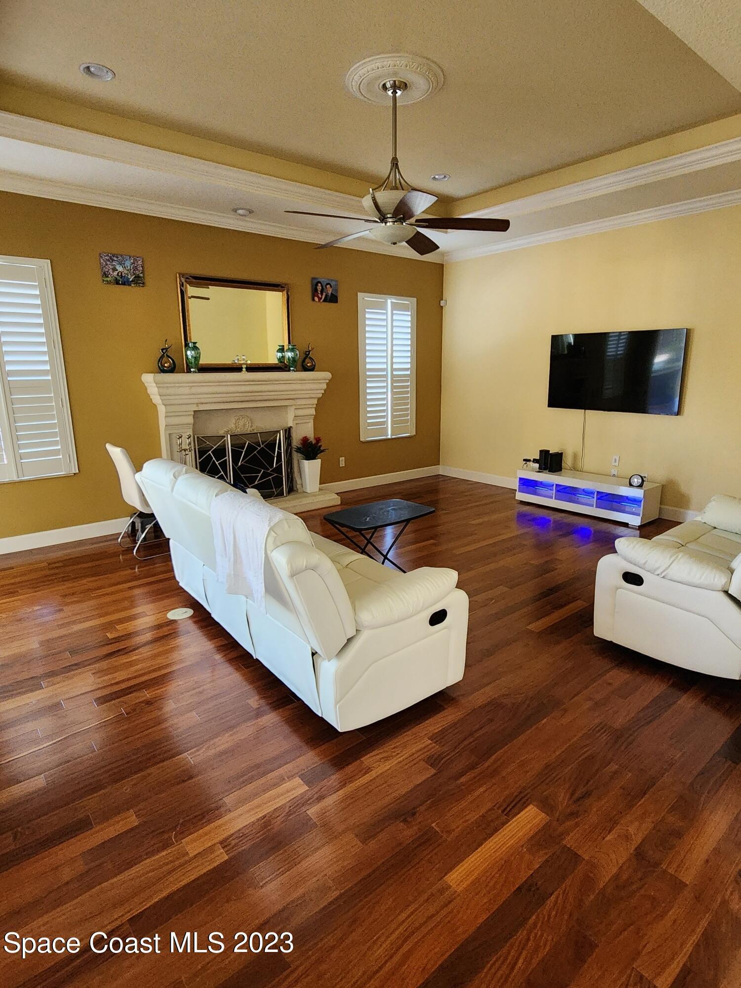 4124 Waterloo Place Melbourne, FL 32940 - Photo 9 of 32 a living room with furniture and a flat screen tv