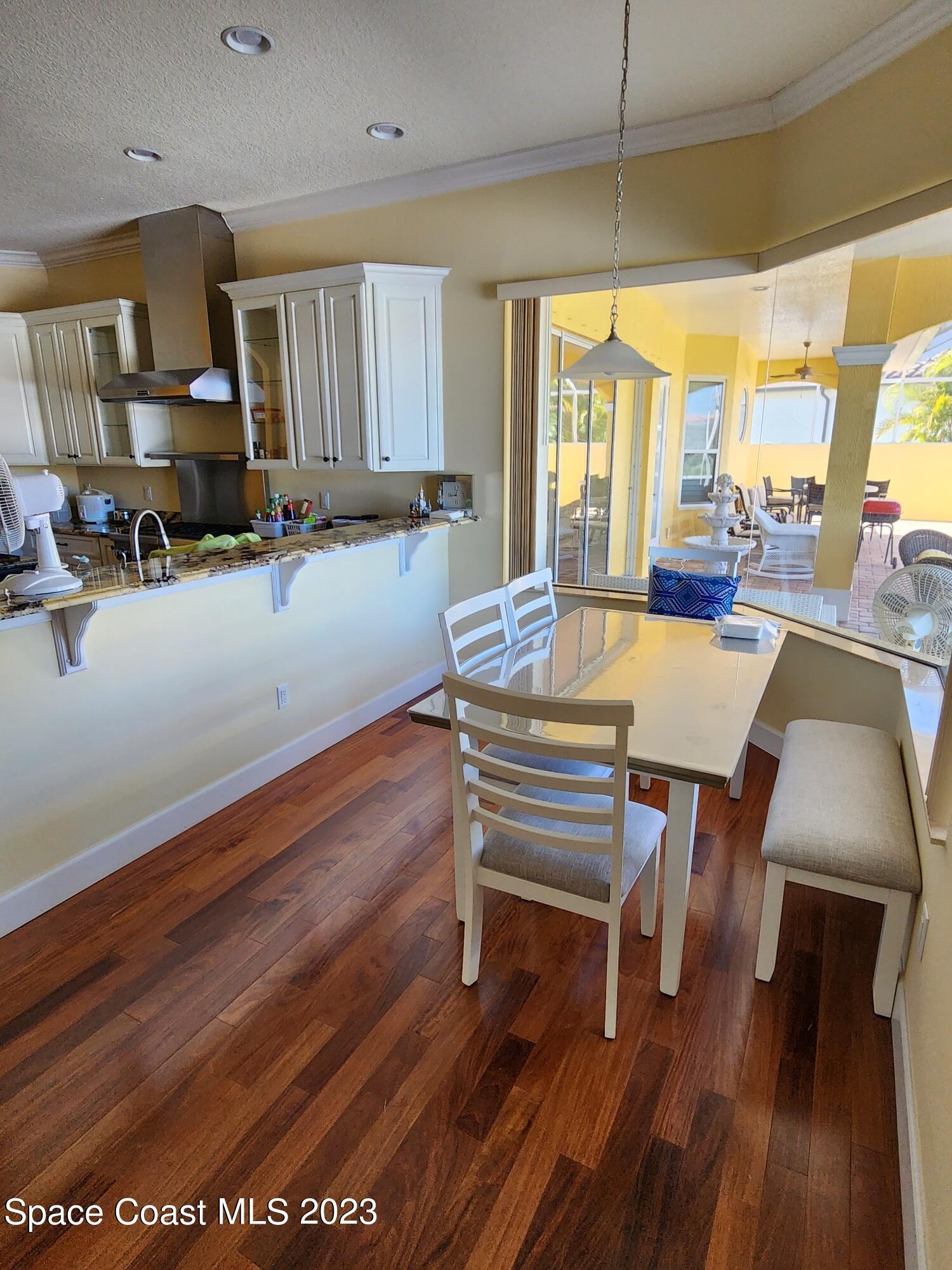 4124 Waterloo Place Melbourne, FL 32940 - Photo 10 of 32 a view of a dining room with furniture window and wooden floor