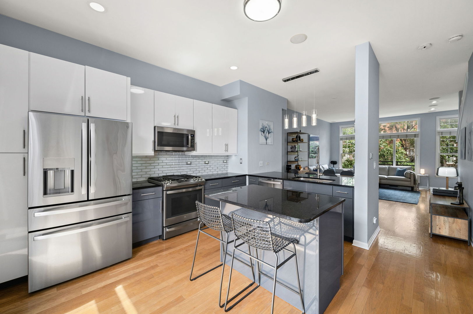813 West University Lane Chicago, IL 60608 - Photo 13 of 33 a kitchen with stainless steel appliances granite countertop a stove and a refrigerator