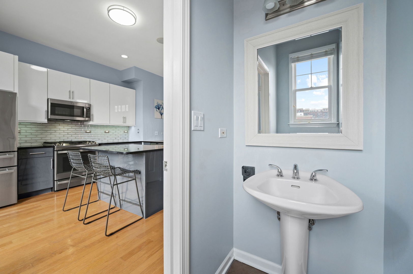 813 West University Lane Chicago, IL 60608 - Photo 16 of 33 a kitchen with stainless steel appliances a sink a stove a table and chairs