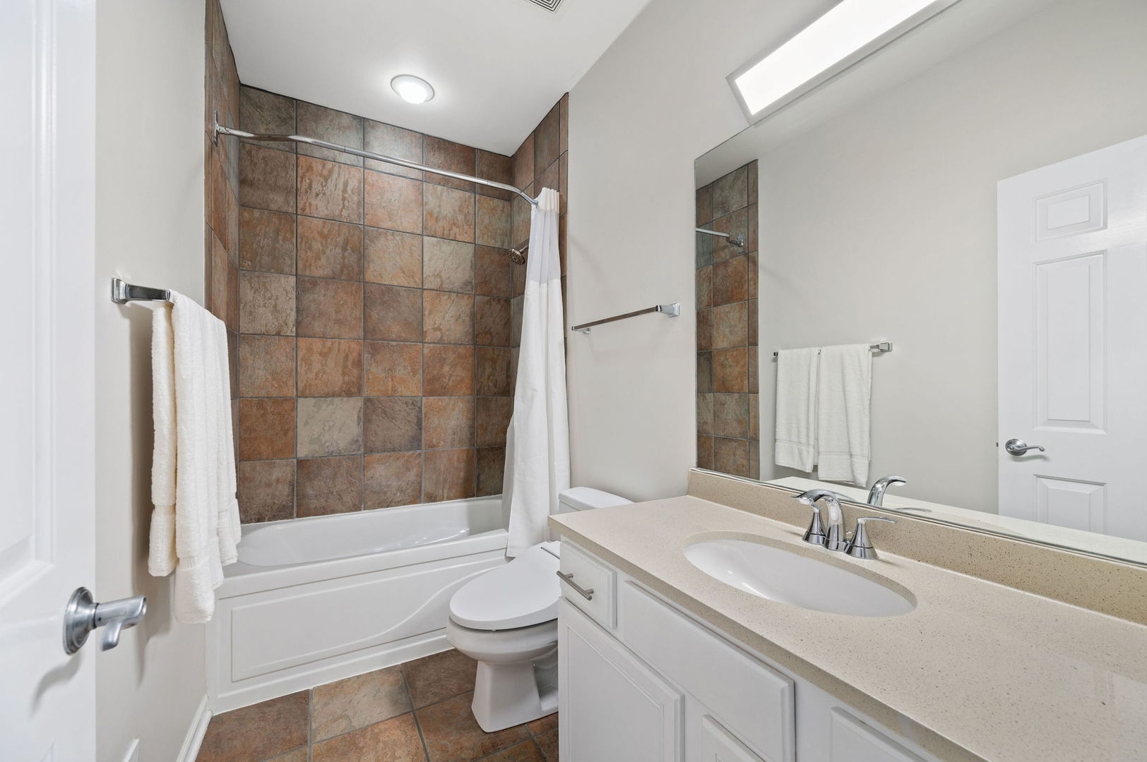 813 West University Lane Chicago, IL 60608 - Photo 23 of 33 a bathroom with a bathtub shower sink vanity mirror and toilet