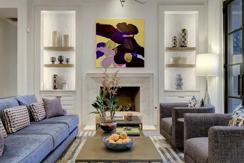 a living room with furniture and a fireplace