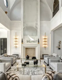 a living room with fireplace furniture and a large window