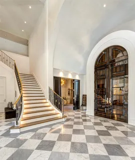 a view of a entryway door of a hall with a rug