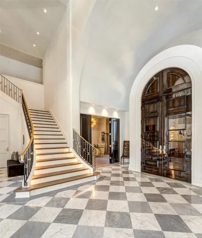 a view of a entryway door of a hall with a rug