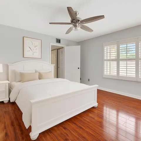 a spacious bedroom with a bed and a window