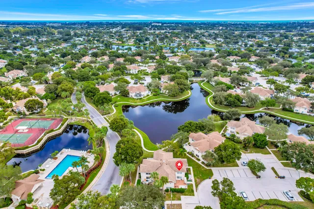 an aerial view of residential houses with outdoor space and street view