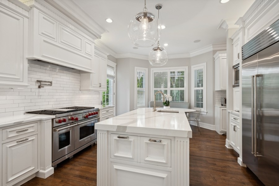 502 Willow Road Winnetka, IL 60093 - Photo 11 of 37 a kitchen with a stove a sink and a refrigerator
