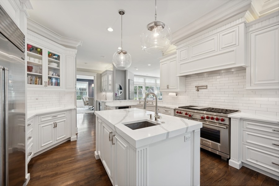 502 Willow Road Winnetka, IL 60093 - Photo 12 of 37 a kitchen with a stove a sink and a refrigerator