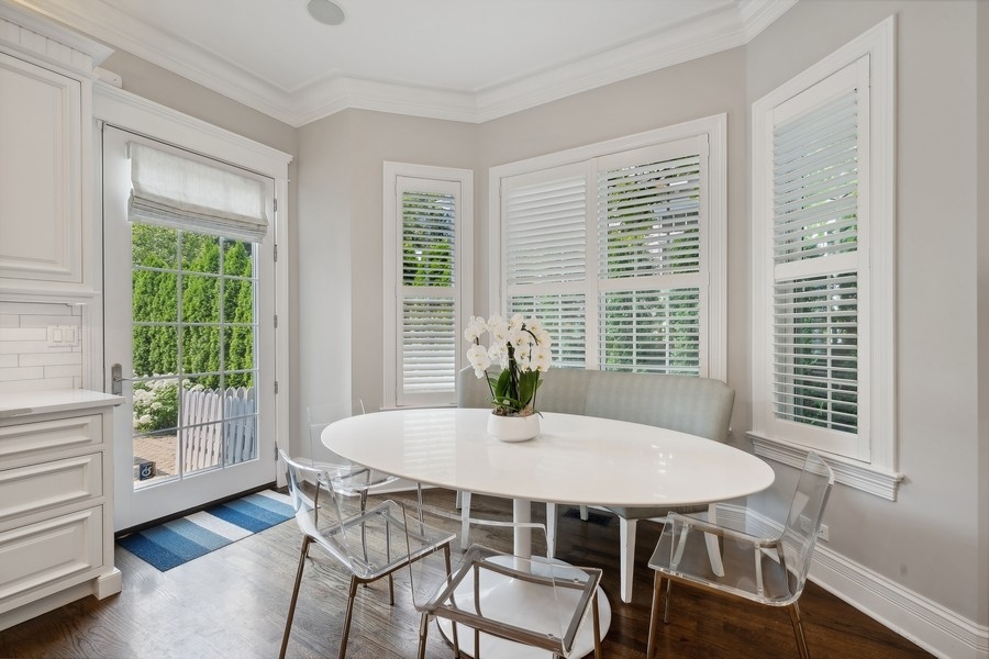 502 Willow Road Winnetka, IL 60093 - Photo 13 of 37 a view of a dining room with furniture window and wooden floor