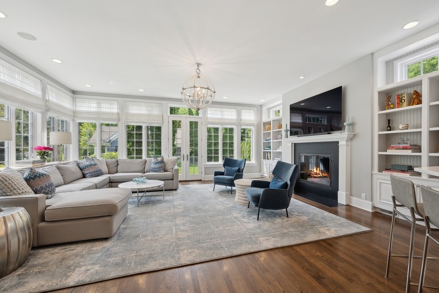 502 Willow Road Winnetka, IL 60093 - Photo 16 of 37 a living room with fireplace furniture and a flat screen tv