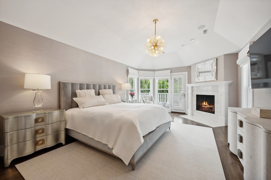 502 Willow Road Winnetka, IL 60093 - Photo 21 of 37 a bedroom with a bed and a fireplace
