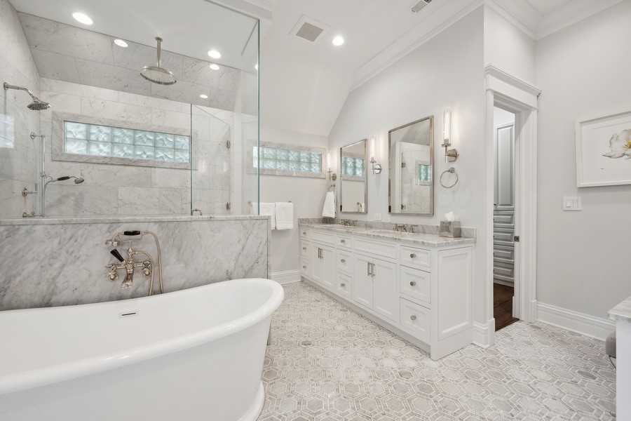 502 Willow Road Winnetka, IL 60093 - Photo 22 of 37 a bathroom with a tub a sink double vanity and a shower