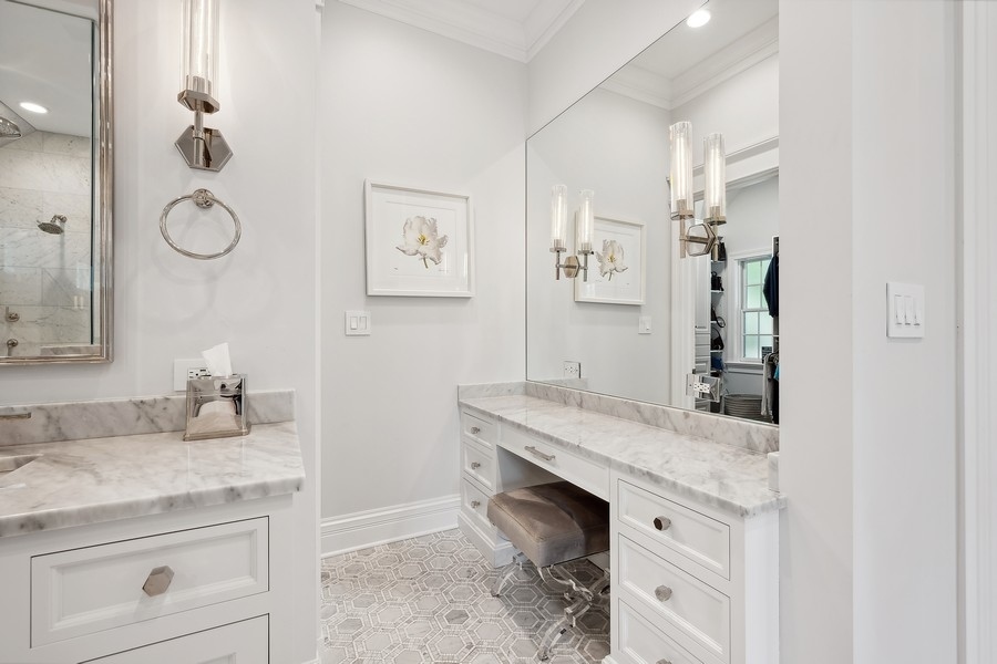 502 Willow Road Winnetka, IL 60093 - Photo 23 of 37 a bathroom with a granite countertop sink and a mirror