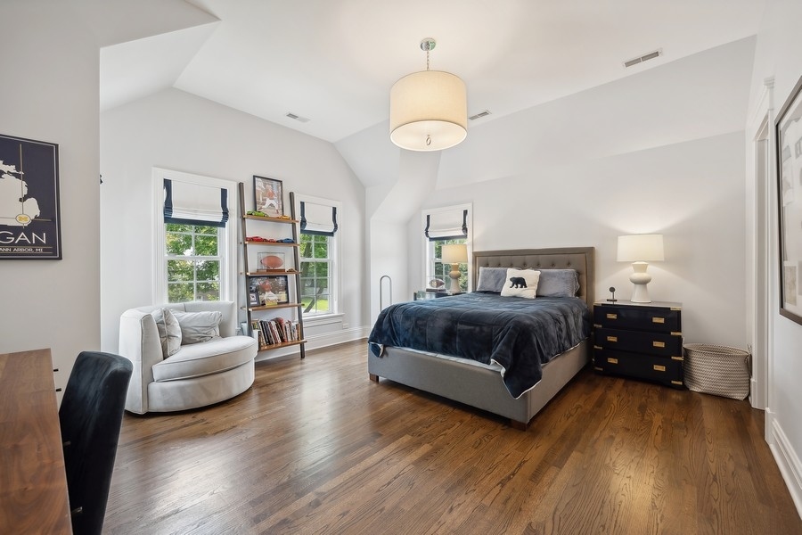 502 Willow Road Winnetka, IL 60093 - Photo 25 of 37 a bedroom with a bed and wooden floor