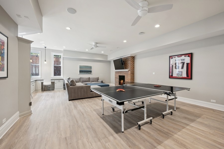 502 Willow Road Winnetka, IL 60093 - Photo 28 of 37 a living room with furniture a wooden floor and a flat screen tv