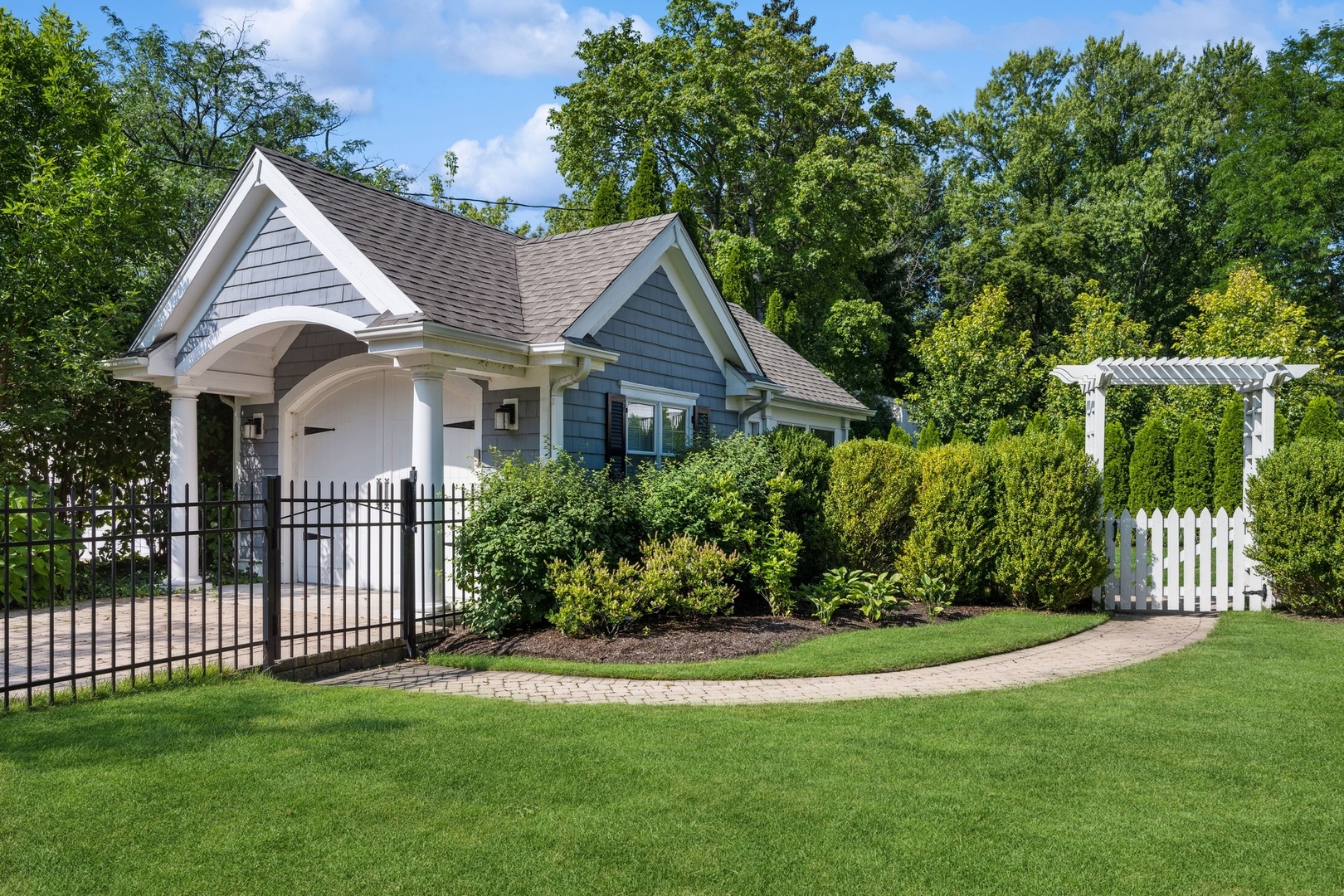 502 Willow Road Winnetka, IL 60093 - Photo 34 of 37 a view of a house with brick walls and a yard with trees