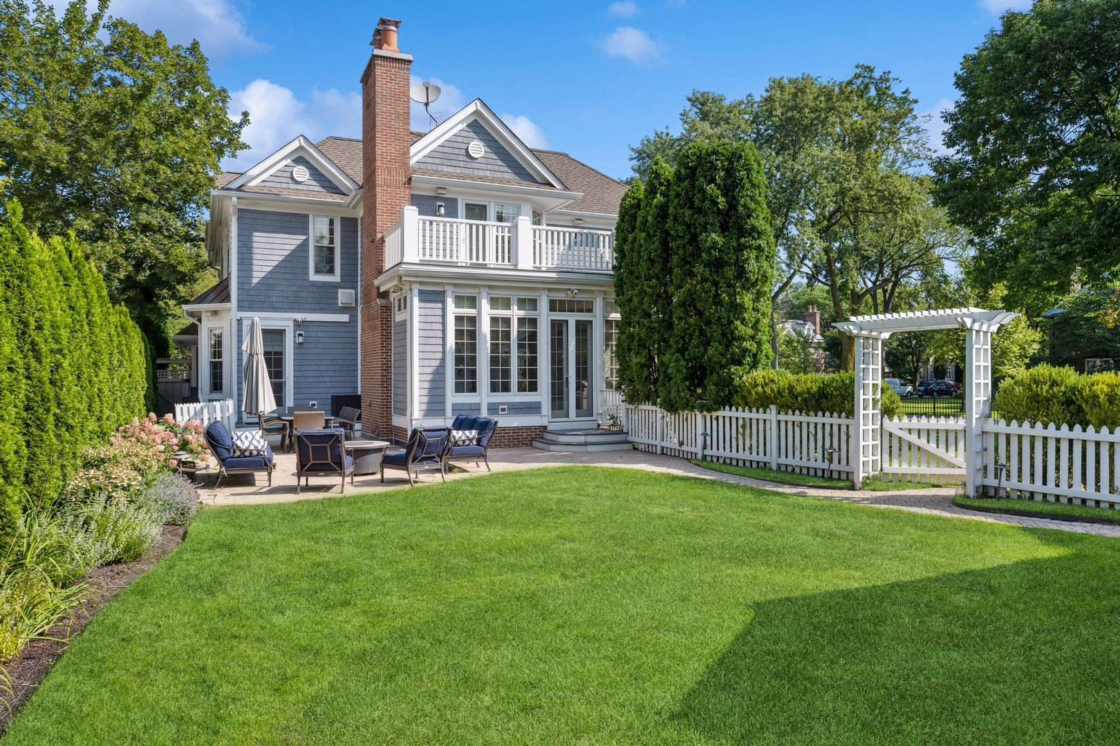 502 Willow Road Winnetka, IL 60093 - Photo 36 of 37 a view of a house with a yard and sitting area