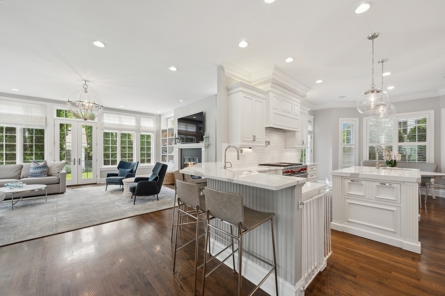 502 Willow Road Winnetka, IL 60093 - Photo 10 of 37 a large kitchen with kitchen island a large island attached living room