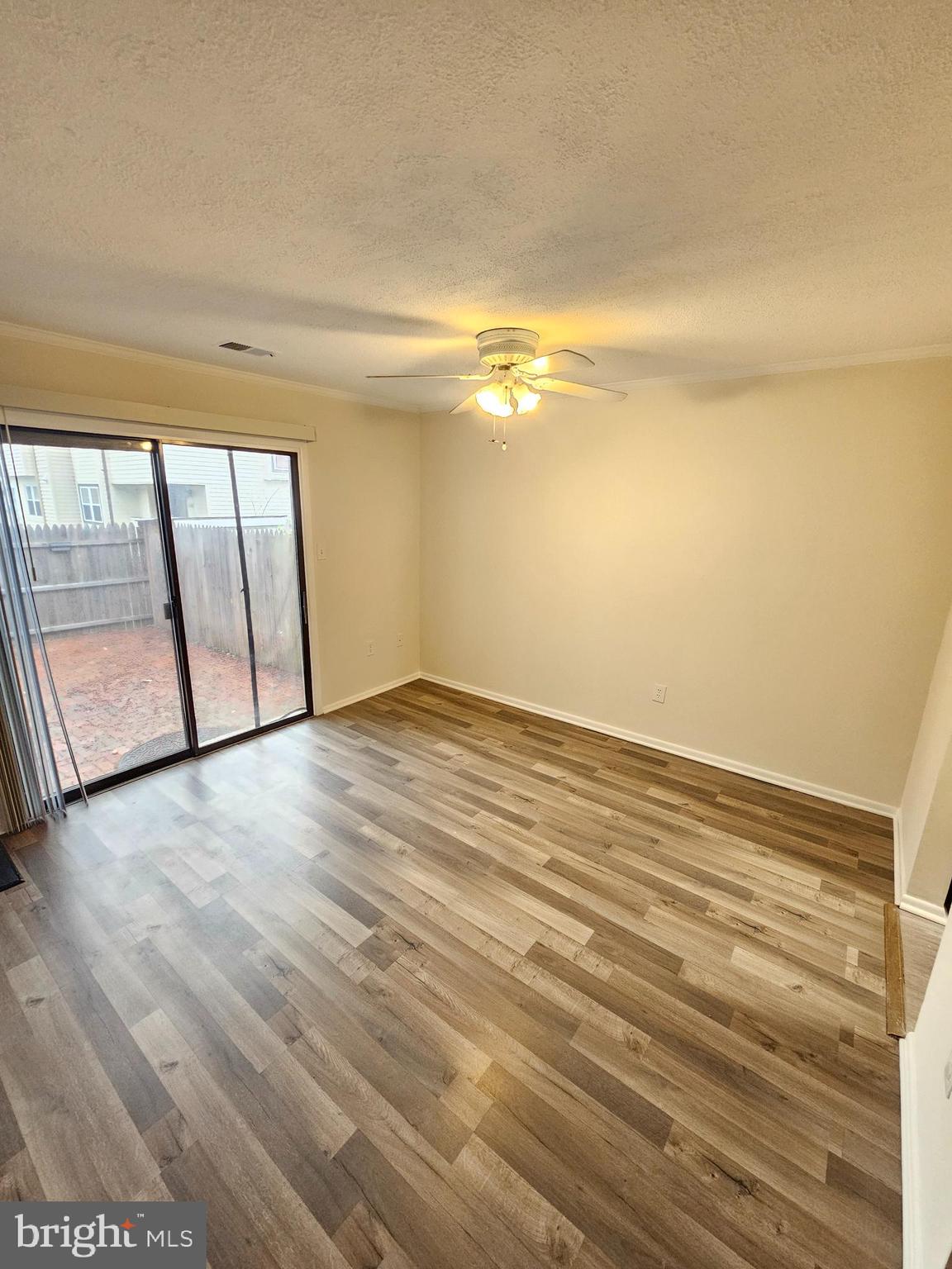 17445 Hoskinson Road Poolesville, MD 20837 - Photo 12 of 37 a view of an empty room with wooden floor and a window