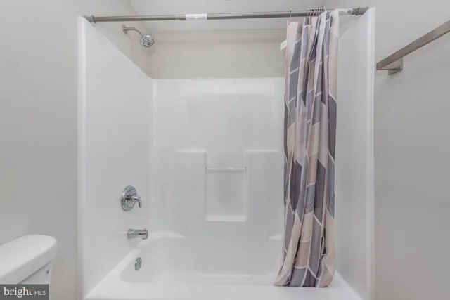 a bathroom with a shower curtain and a sink