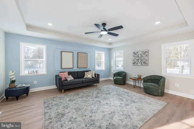 a living room with furniture a window and a potted plant