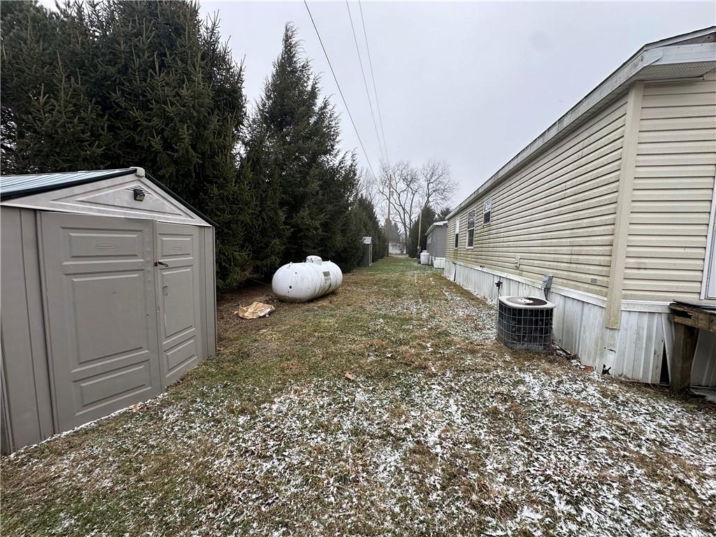 101 Haylees Lane Butler, PA 16002 - Photo 9 of 14 a view of a backyard with table and chairs and wooden fence