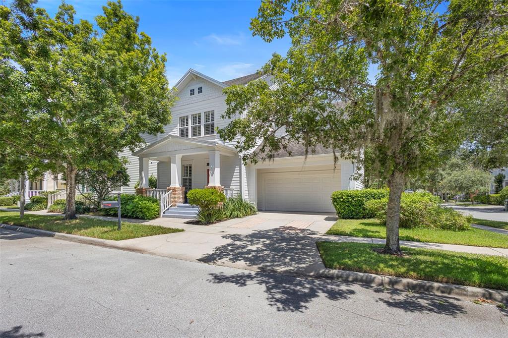 907 Pawstand Road Celebration, FL 34747 - Photo 1 of 49 a front view of a house with a garden and trees
