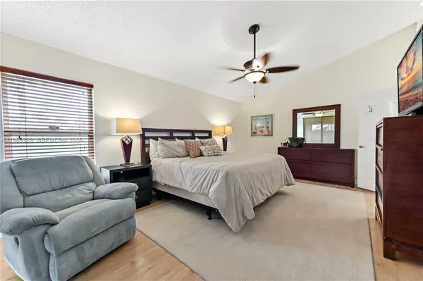 a bedroom with bed couch and window