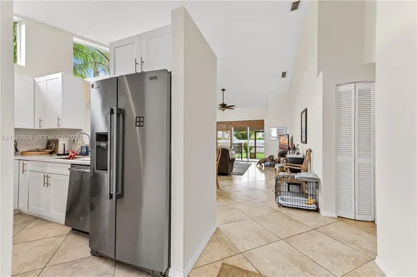 a kitchen with stainless steel appliances a refrigerator and stove top oven