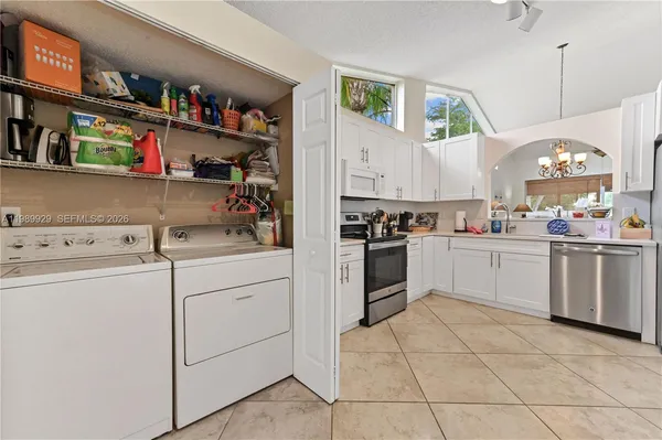 a kitchen with cabinets and white appliances