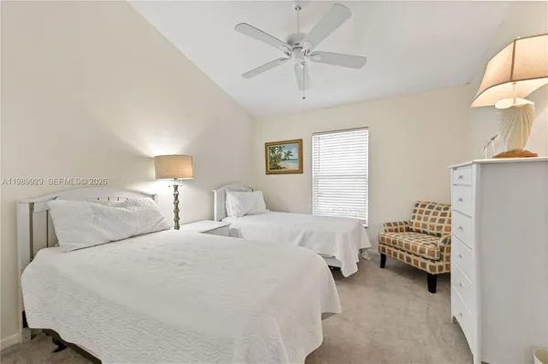 a bedroom with bed and a chandelier