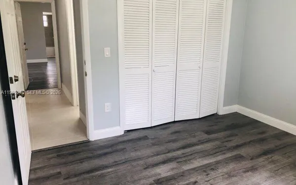 an empty room with wooden floor