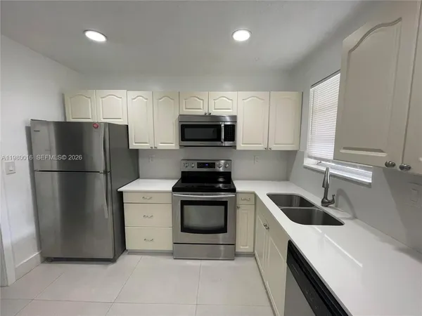 a kitchen with a refrigerator sink and stove