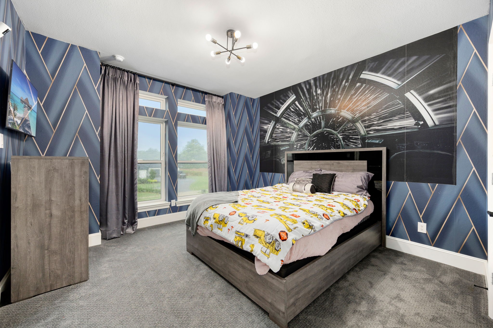 29419 Cir S Rnch Trail Fulshear, TX 77406 - Photo 27 of 45 Another custom secondary bedroom upstairs features a distinctive space-themed wall graphic design, high ceilings and dual windows looking toward the front landscape.