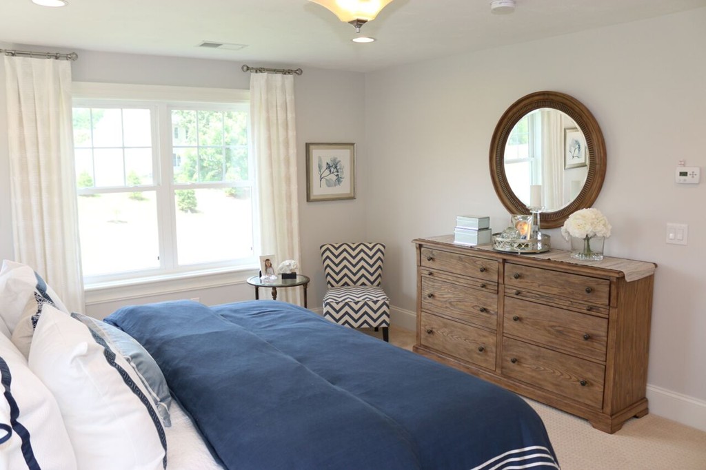 127 Oxbow Road Wayland, MA 01778 - Photo 3 of 3 a bedroom with a bed a mirror on dresser and a window