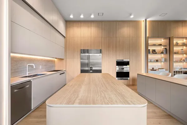 a kitchen with kitchen island a counter top space appliances and a window