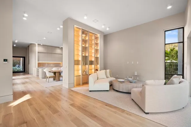 a living room with furniture and large windows