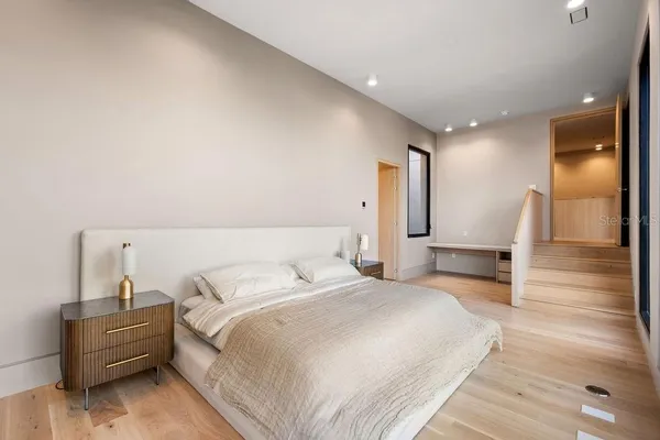 a bedroom with a bed and a view of kitchen