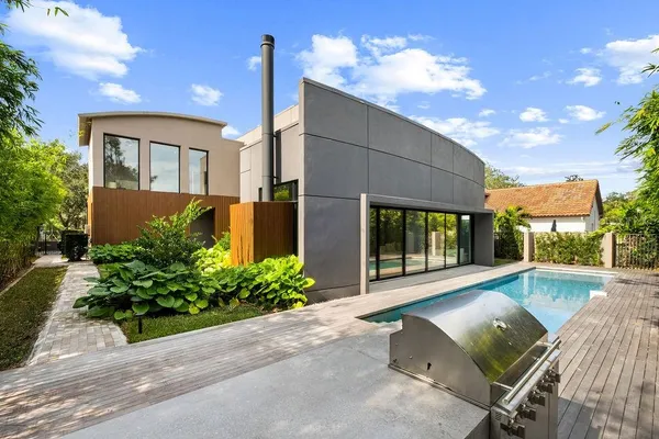 a view of a house with backyard and sitting area