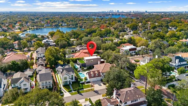 an aerial view of residential houses with outdoor space and ocean view
