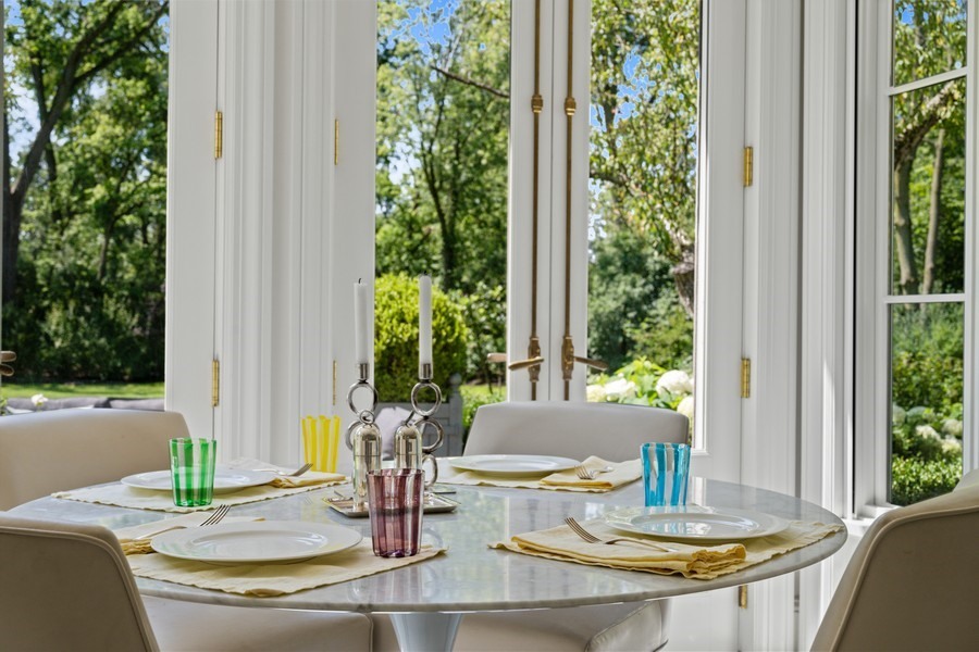 40 Woodley Road Winnetka, IL 60093 - Photo 22 of 60 a view of a dining room with a table and chairs in the patio